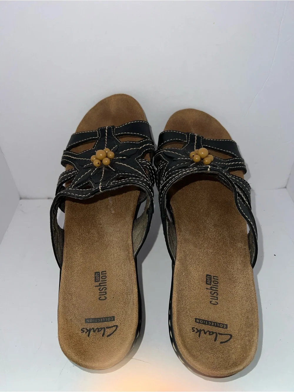 Clarks Women’s Black Leather Slip-On Sandals with Flower Accent